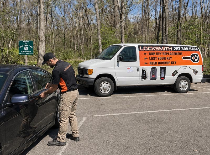 Car Keyline Automotive Locksmith working on a car in front fo Etra Lake Park Windsor NJ
