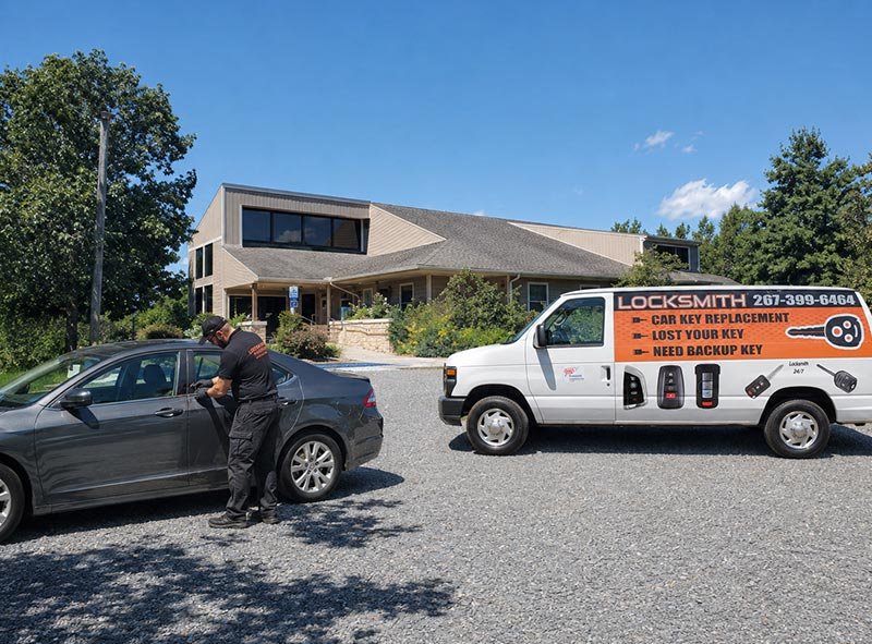 Car Keyline Automotive Locksmith working on a car in front of Plainsboro Preserve Plainsboro NJ